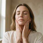 Face massage beauty tips — woman sweeping her jawline for an instant glow
