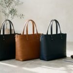 Best designer bags for professional women photographed with a laptop